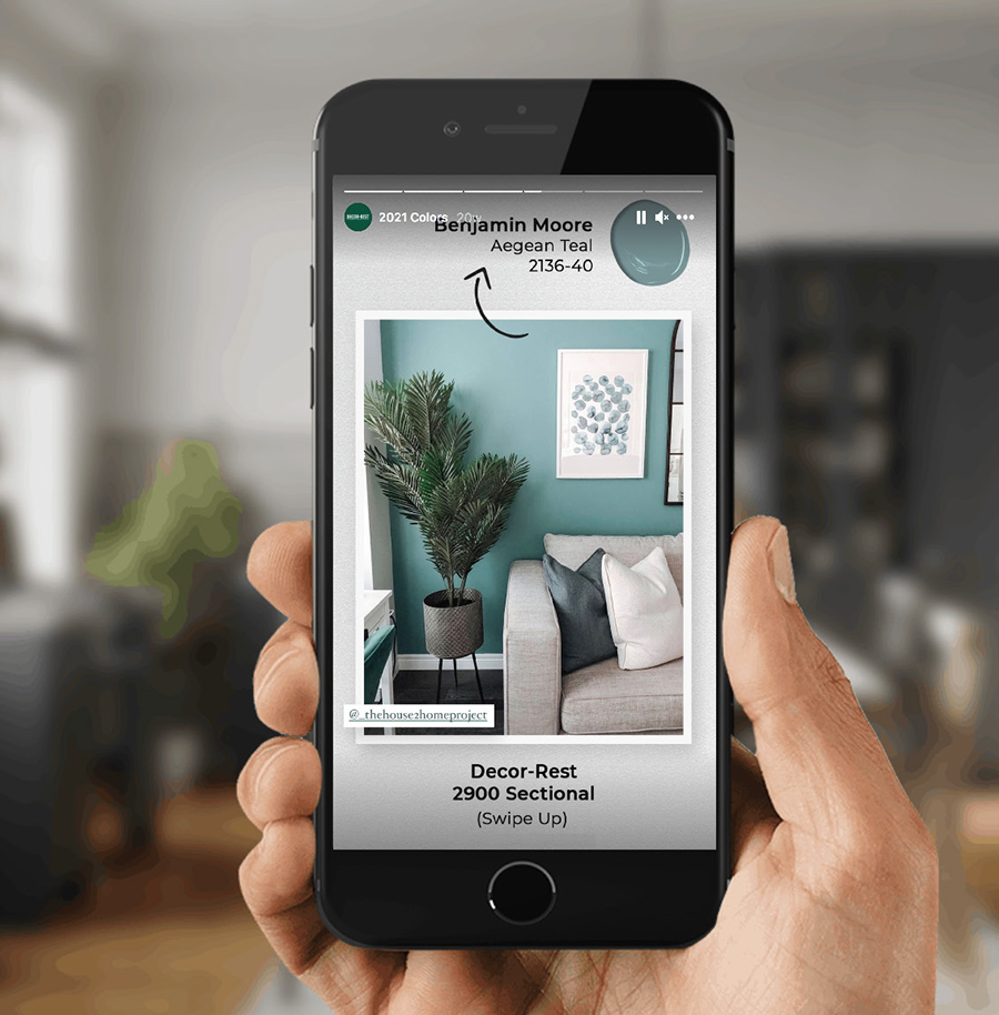 Holding a Cellular phone showing on DECOR-REST Instagram post of the 2900 sectional with 2021 color of the year from Benjamin Moore color Aagean Teal 2136-40 - What’s_An_IG_Story_900x914.jpg 